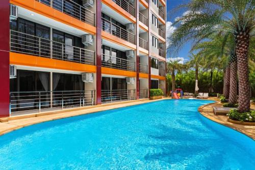 a large swimming pool in front of a building at 1 BR Apt MBC 1503 near Mai Khao Beach and Airport in Mai Khao Beach
