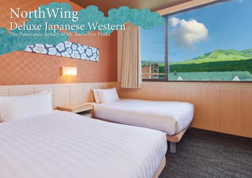 two beds in a room with a large window at Kamenoi Hotel Aso Park Resort in Aso