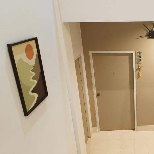 a painting hanging on a wall in a room at The Beginning Hotel in Betong