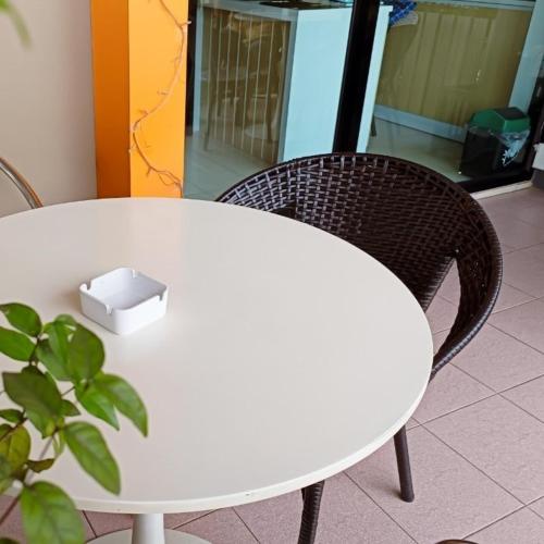 a white table and two chairs with a box on it at The Beginning Hotel in Betong