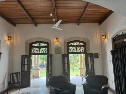 a lobby with two doors and chairs and a ceiling at Villa Sandamedura in Koggala