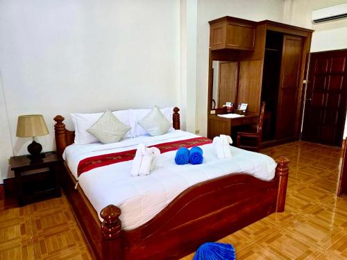 a bedroom with a large bed with towels on it at Happy Lagoon Bungalow in Khao Lak