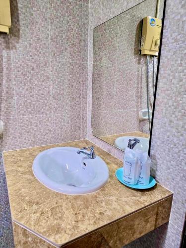 a bathroom with a sink and a mirror at Happy Lagoon Bungalow in Khao Lak