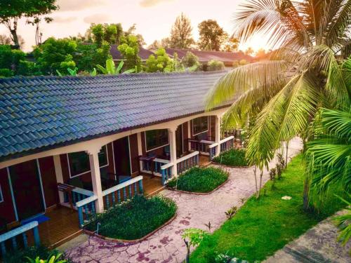 an aerial view of a house with a palm tree at Happy Lagoon Bungalow in Khao Lak