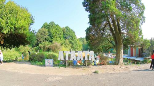 a group of people walking around a park at Ataata Resort in Iga