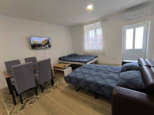 a living room with a bed and a couch at Zoka in Surčin