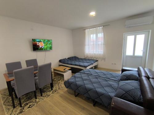 a bedroom with a bed and a living room at Zoka in Surčin