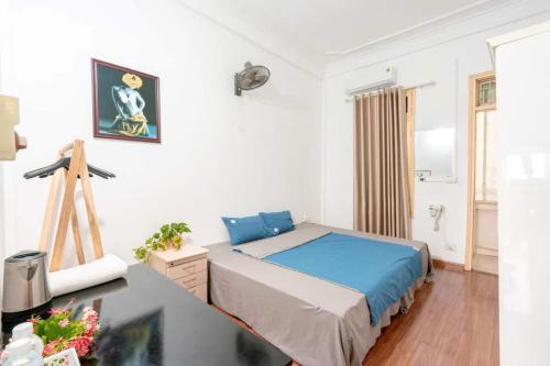 a bedroom with a bed and a desk in it at Homestay HaNoi Amazing in Hanoi