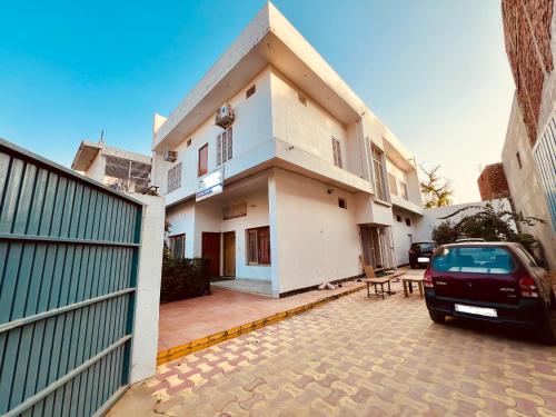 a house with a car parked in front of it at Vivanta Home Stay in Ayodhya