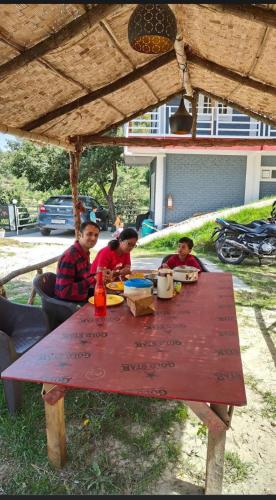 a group of children sitting at a picnic table at Saanidhya Sunset View Villa in Mukteswar
