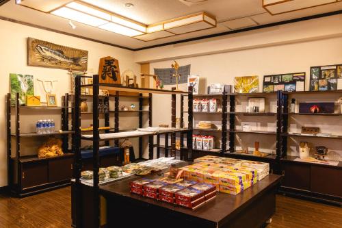 a store with a counter with food on it at Shikishimaso in Higashikawa