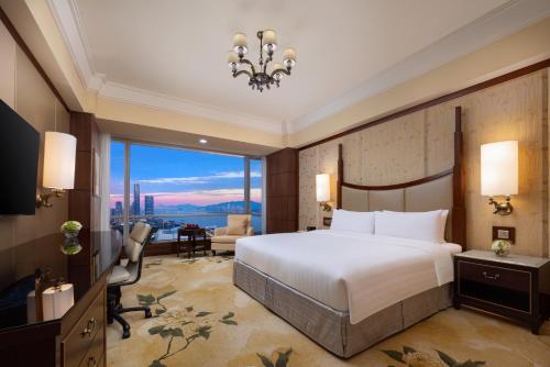 a bedroom with a bed and a large window at Shangri-La Wenzhou in Wenzhou
