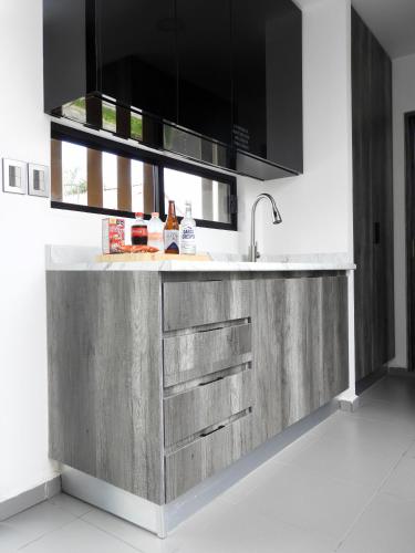 a kitchen with a stainless steel counter with a sink at L W H Hotel & Glamping Container Park in Silao