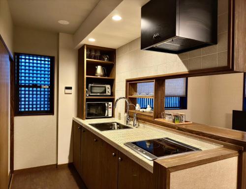 a kitchen with a sink and a counter top at 古月居 Koduki House京都四条 in Kyoto