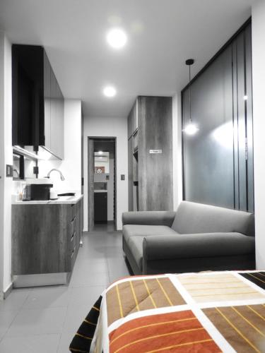 a living room with a couch and a kitchen at L W H Hotel & Glamping Container Park in Silao