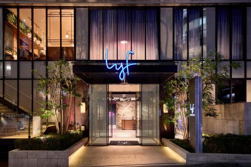 a lobby of a building with a neon sign on it at lyf Shibuya Tokyo in Tokyo