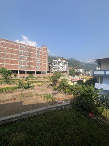 a view of a city with buildings in the background at Prakruti Homestay in Rishīkesh