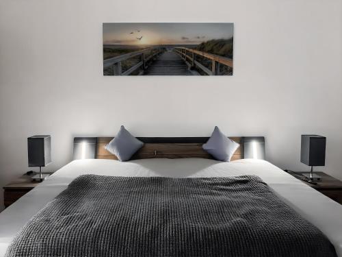 a bedroom with a white bed with two speakers at Bamberg Burgblick in Bamberg