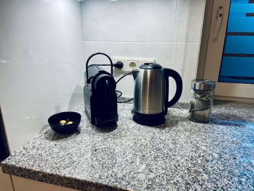 a kitchen counter with a coffee maker and a kettle at Appartement 3 - geräumige Wohnung mit eigener Küche, Bad und Gartenblick in Salzgitter