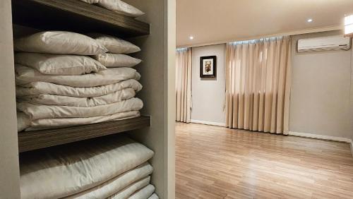 a room with a bunch of pillows in a closet at Jeonju Pungnam Family Hotel in Jeonju