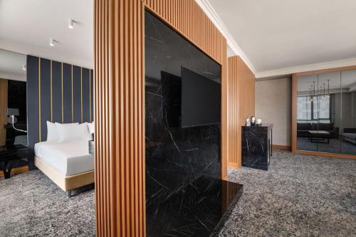 a hotel room with a large fireplace with a bed at Ramada by Wyndham Gaziantep in Gaziantep