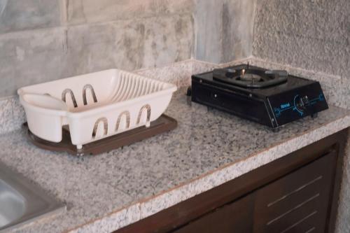 a kitchen counter with a toaster and a radio at ME Villa Pererenan in Canggu