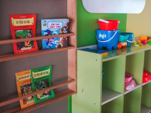 a childs play room with books shelves and toys at Dusit Princess Moonrise Beach Resort in Phu Quoc