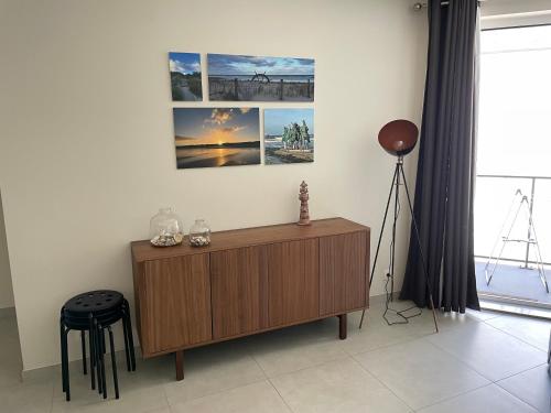 a living room with a wooden cabinet and a tripod at Residentie Marie-Julie in Middelkerke