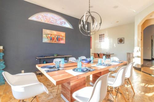 a dining room with a wooden table and white chairs at 5 Acre Villa Retreat with Vineyard Pool Spa & Amazing Views of Sonoma County in Sebastopol