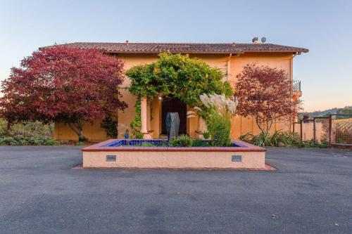 a house with a garden in front of it at 5 Acre Villa Retreat with Vineyard Pool Spa & Amazing Views of Sonoma County in Sebastopol