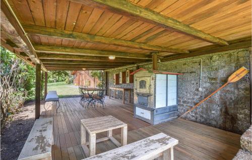 a covered deck with a stove and a table at Amazing Home In Caprarola With Kitchen in Caprarola