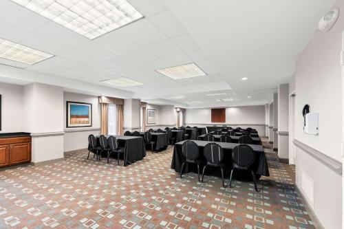 a conference room with tables and chairs and a podium at Hampton Inn Pennsville in Pennsville