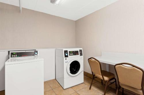 a laundry room with a washing machine and a table at Hampton Inn Pennsville in Pennsville