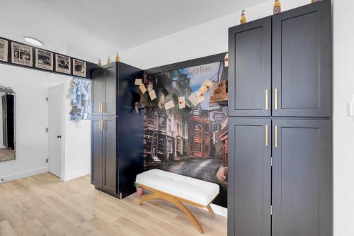 a room with a closet and a bench and a wall at A Wizards Stay Hogwarts Way in Las Vegas