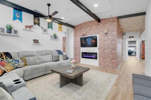 a living room with a couch and a brick wall at A Wizards Stay Hogwarts Way in Las Vegas