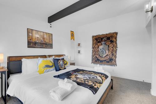 a bedroom with a bed with white sheets at A Wizards Stay Hogwarts Way in Las Vegas