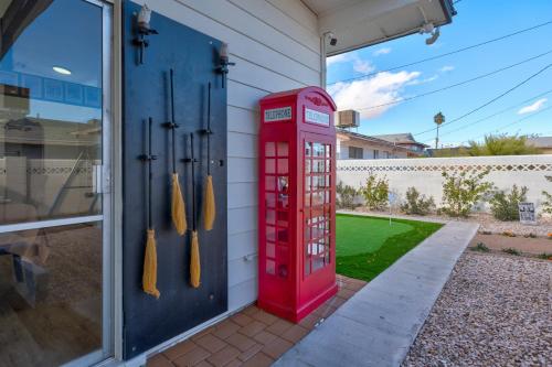 a red phone booth sitting outside of a house at A Wizards Stay Hogwarts Way in Las Vegas