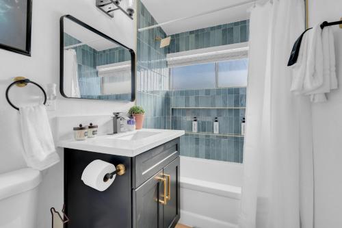 a bathroom with a sink and a mirror and a shower at A Wizards Stay Hogwarts Way in Las Vegas
