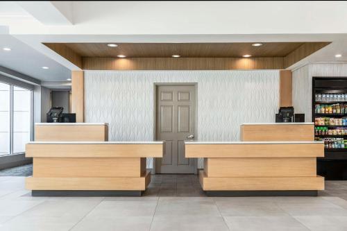 a lobby of a store with wooden counters at Hilton Garden Inn Denver Airport in Aurora
