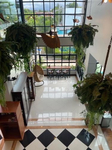 a view of a room with potted plants in a building at Socool Grand Hotel in Nang Rong