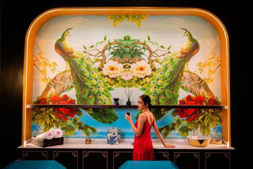 a woman in a red dress standing in front of a stage at The Soul Resort in Sara Buri