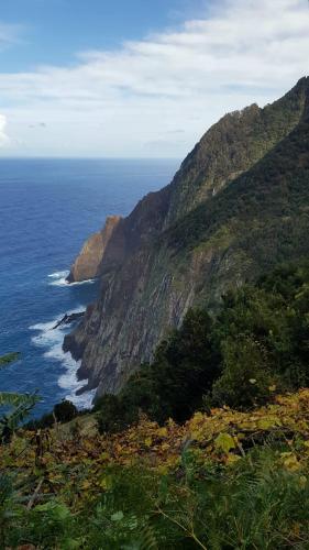 a view of the ocean and a mountain at Revived in Porto da Cruz