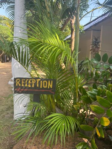 a sign that says rejection in front of plants at STARFISH beach bungalow in Arugam Bay