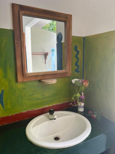 a bathroom with a sink and a mirror at STARFISH beach bungalow in Arugam Bay