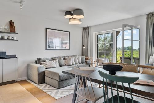 a living room with a couch and a table at Alte Schule Westerhever Welt in Westerhever