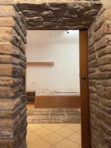 a view through a stone wall into a bedroom at Star in Poprad