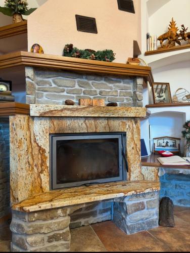 a stone fireplace with a tv on top of it at Star in Poprad