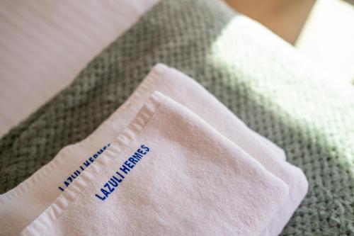 a white napkin sitting on top of a bed at Lazuli Hermes Apartments in Larnaka