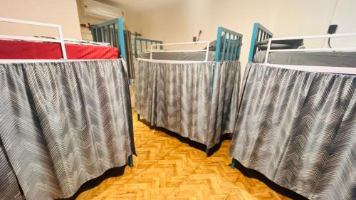 three beds are lined up in a room at Garden Aroma Palolem, Beachside Hostel & Cafe Bar in Palolem