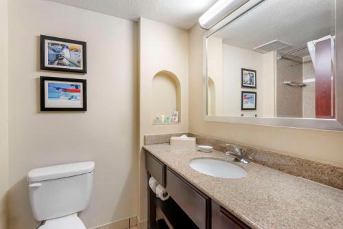 a bathroom with a toilet and a sink with a mirror at Comfort Inn & Suites Tavares North in Tavares